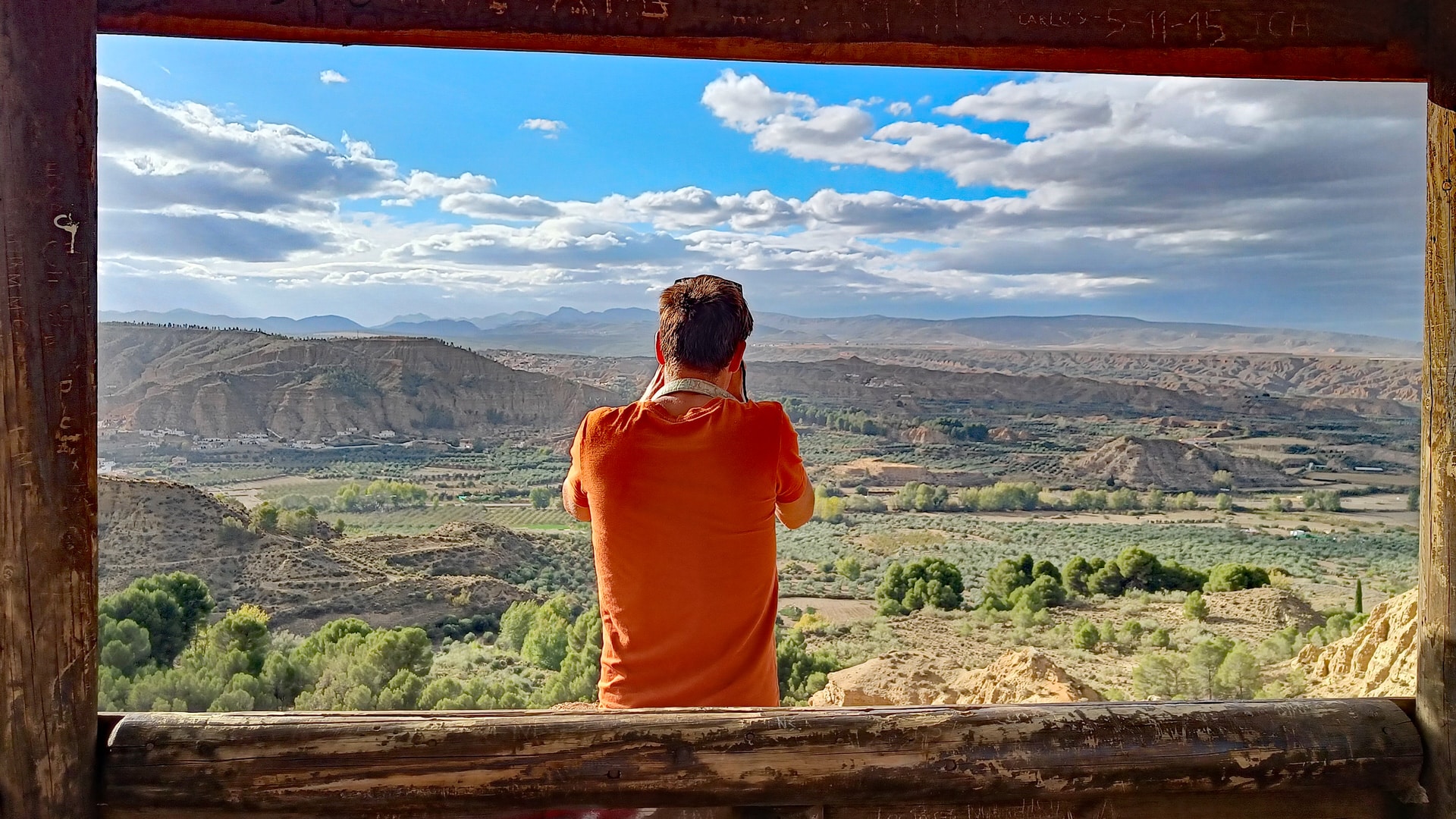 Photographer taking a picture of the Geopark of Granada in the viewpoint of Marchal. Andalusia