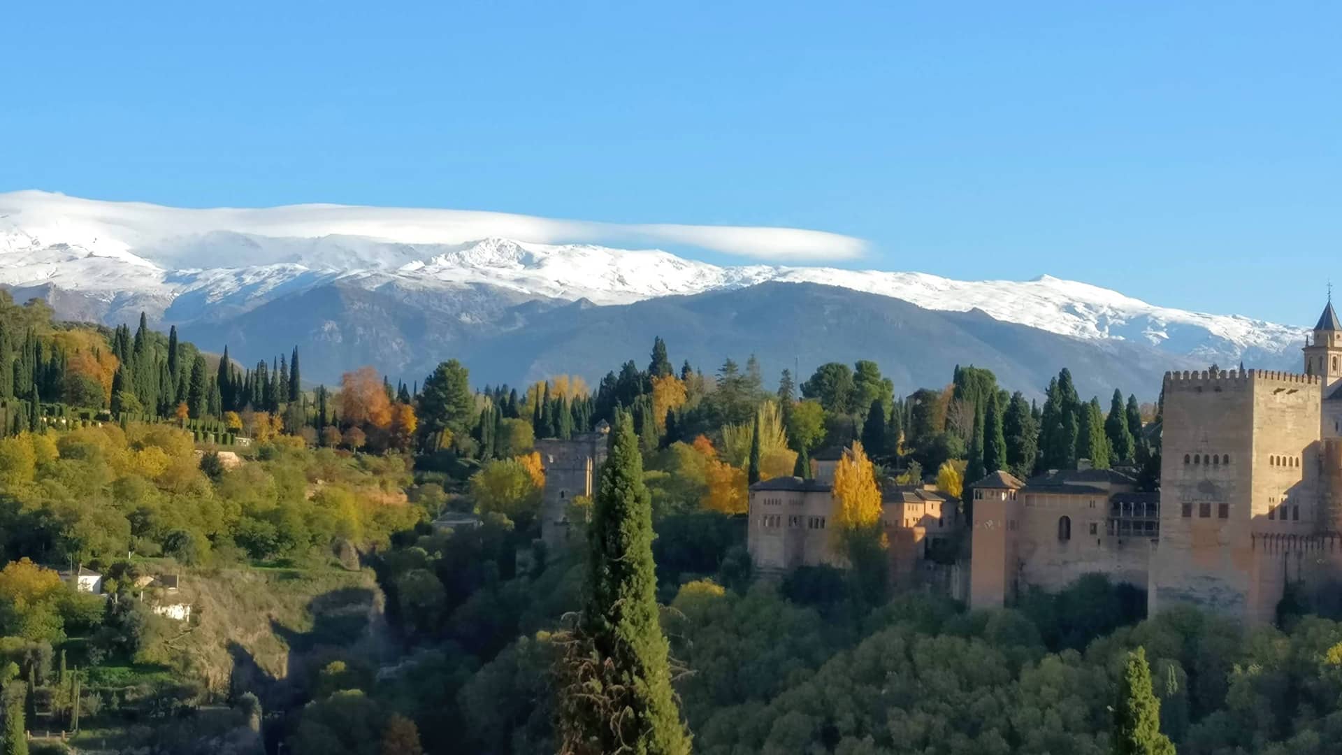 Views of the Alhambra in Granada with the snow capped mountains of Sierra Nevada, Andalusia