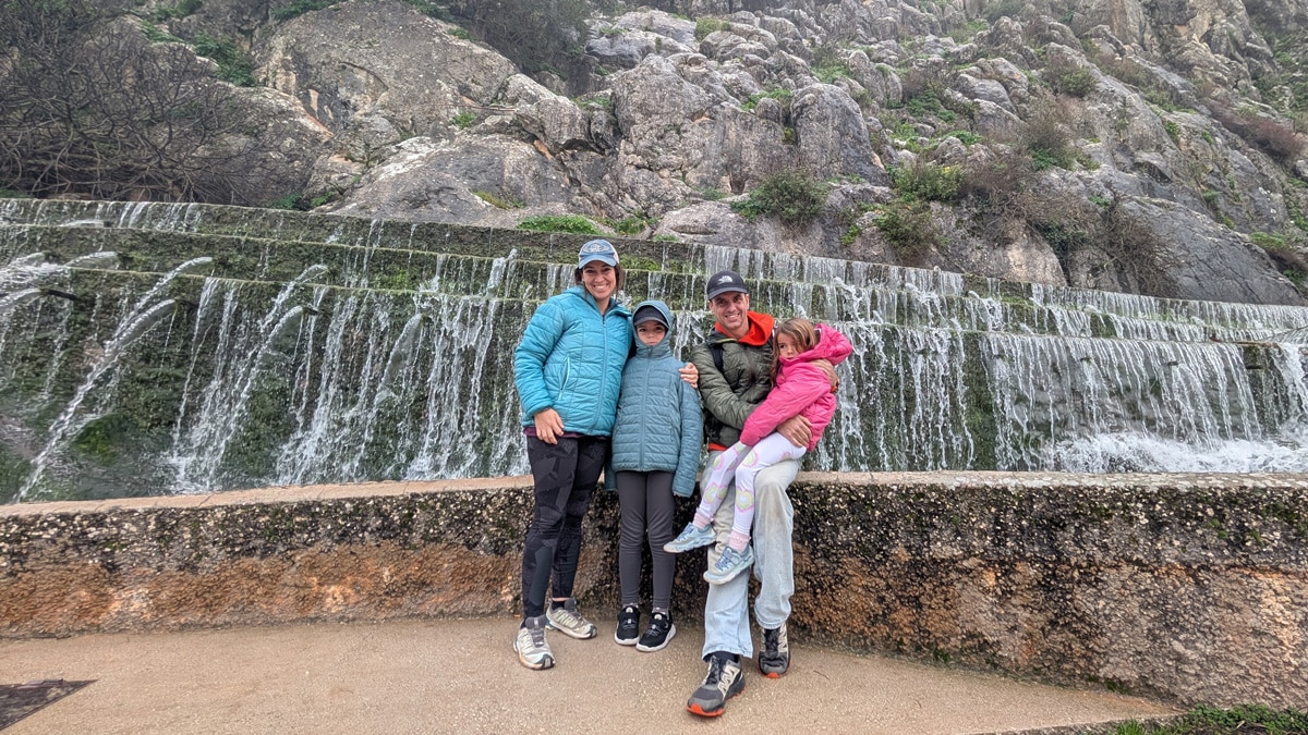 The family posing in front of the Fuente de los 100 caños in Málaga
